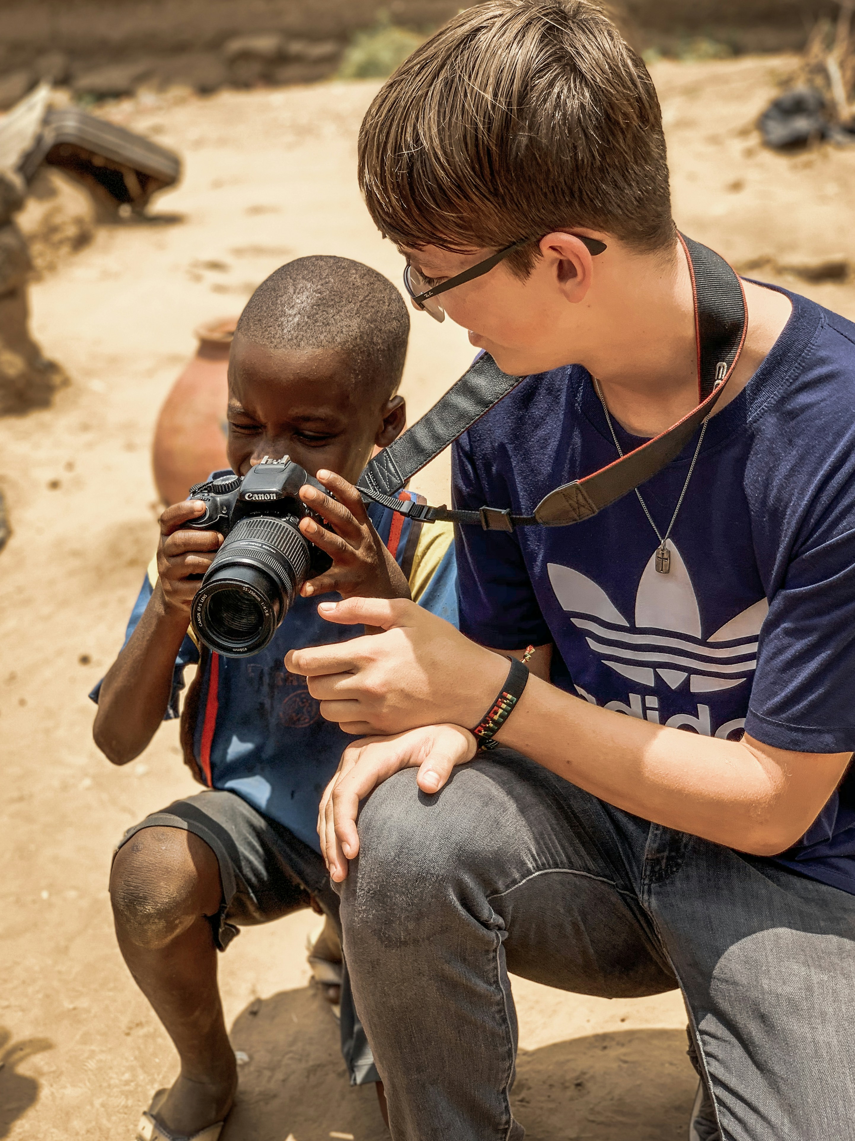 A guide showing a child how to use a camera